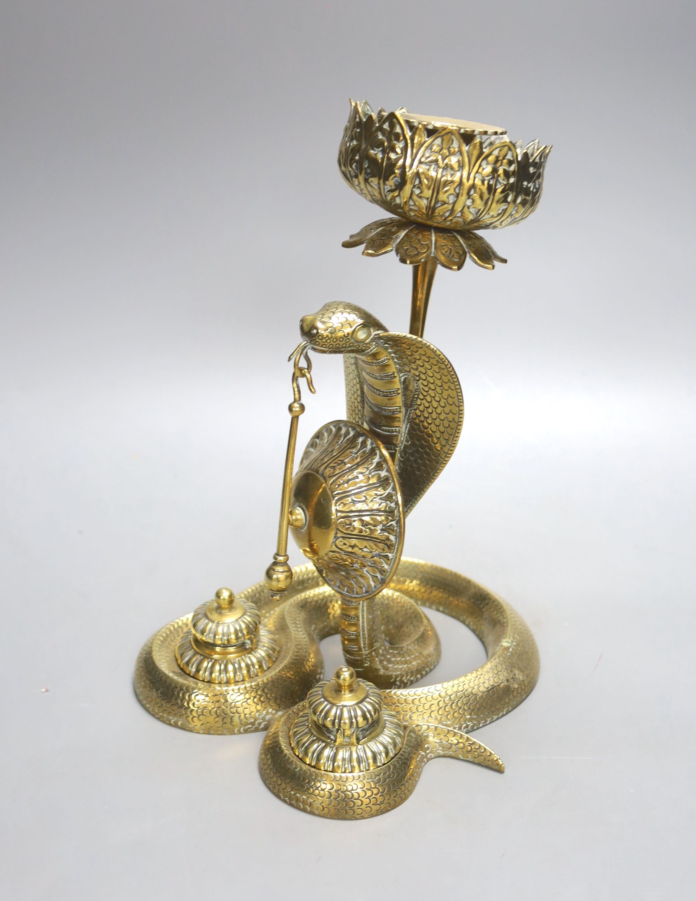 An Indian brass ‘cobra’ desk stand, 26 cms high.